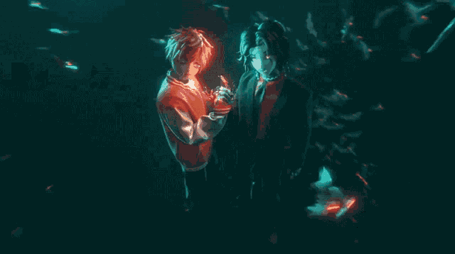 a man and a woman are hugging in the dark .