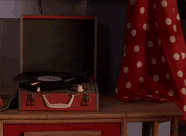 a red suitcase with a record player inside of it