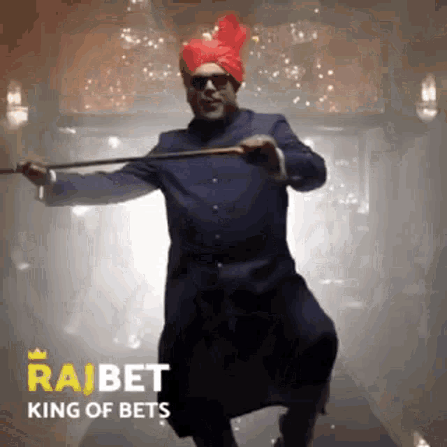 a man wearing a turban and sunglasses is holding a cane .