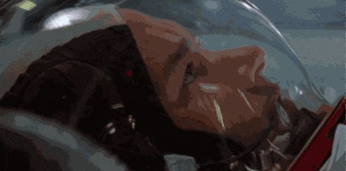 a close up of a man 's face in a space suit