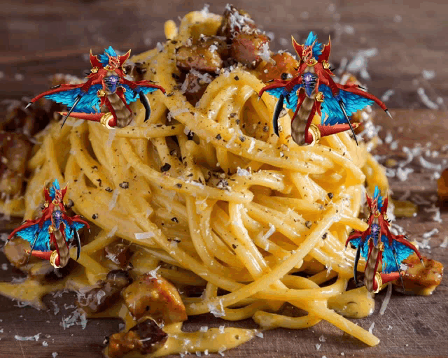 a close up of a plate of pasta with a dragon on top of it