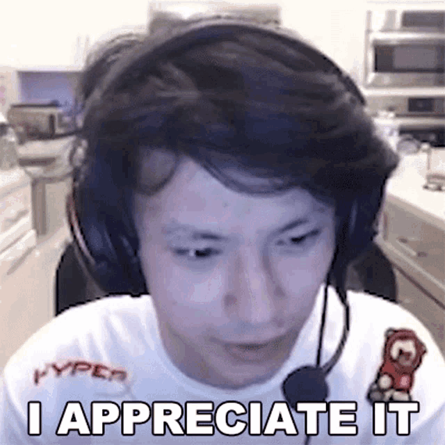 a man wearing headphones and a microphone says `` i appreciate it '' while looking at the camera .