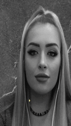 a black and white photo of a woman wearing earbuds