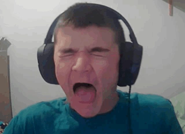 a man wearing headphones is making a funny face with his mouth open