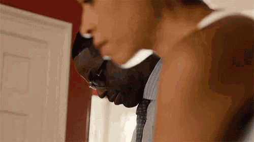 a man and woman are standing next to each other in a room .