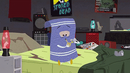 a cartoon character is sitting on a bed with a poster that says stoned dead