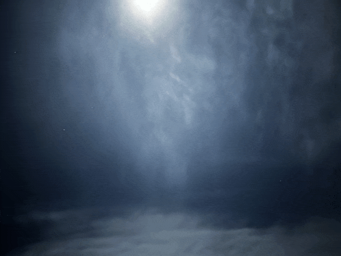 the sun shines through the clouds in a dark sky
