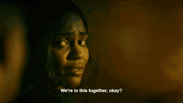 a woman in a dark room says we 're in this together , okay .