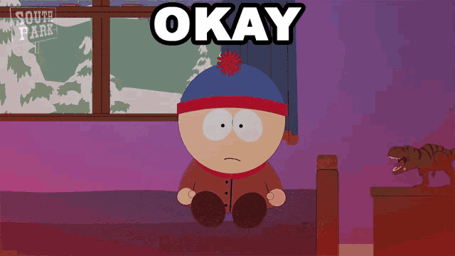 stan marsh from south park sits on a bed with the word okay above him