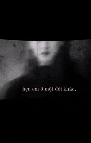 a black and white photo of a person 's face with the words `` hen em o mot doi khach '' in the corner .