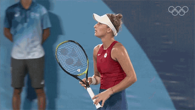 a woman is holding a tennis racquet in front of a scoreboard that says 39