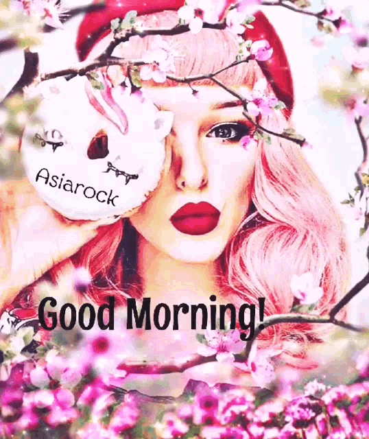 a woman with pink hair is holding a donut in front of her eye and says good morning .