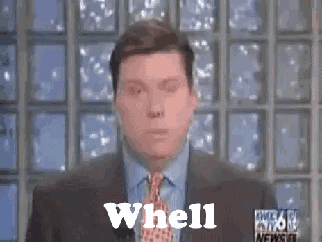 a man in a suit and tie with the word whell on his face