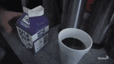a carton of ice cream is being poured into a cup