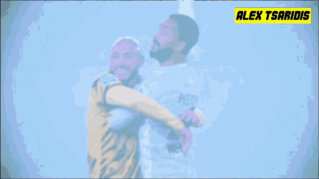 two soccer players are hugging and one has the number 42 on his jersey