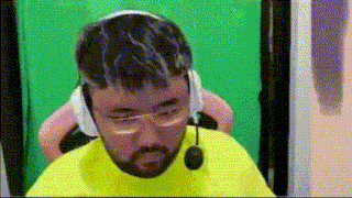 a man with a beard is wearing headphones and a microphone .