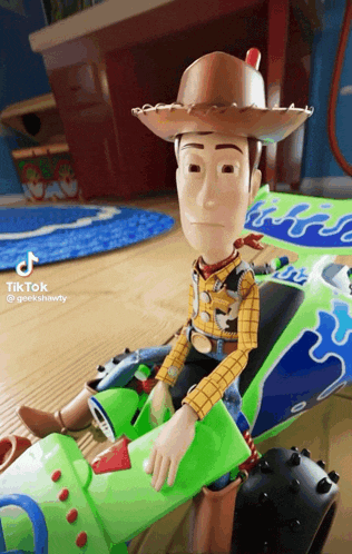 woody from toy story is sitting on buzz lightyear 's toy car