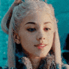 a close up of a woman 's face with a ponytail and a crown on her head .