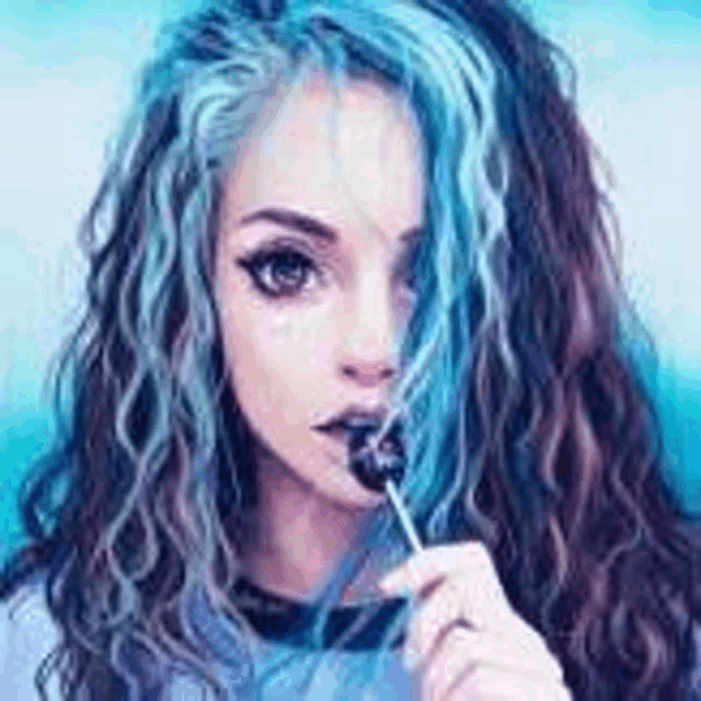 a girl with blue hair is eating a lollipop in front of her face .