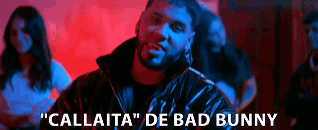 a man with a beard is standing in front of a group of people and says " callaita "