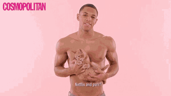 a shirtless man is holding a black cat that says meow