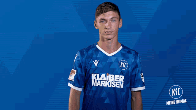 a soccer player wearing a blue shirt that says ksc