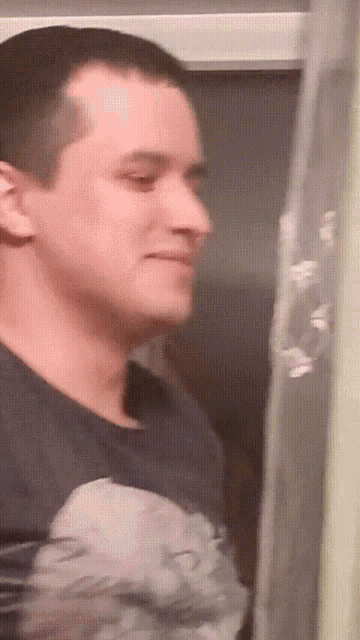 a man wearing a black shirt with a picture on it