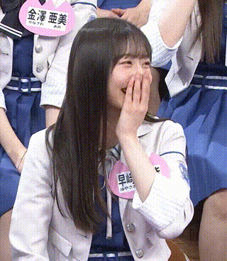 a girl with a name tag that says ' 早 崎 ' on it is laughing