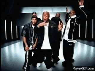 a group of men are dancing in a room with a makeagif.com watermark