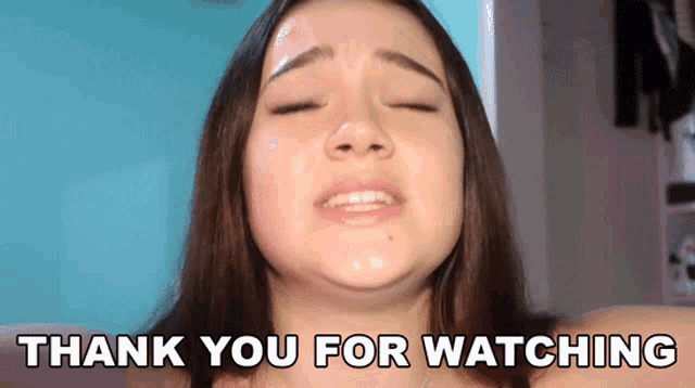 a woman says " thank you for watching " in front of her face