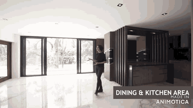 a woman stands in a dining and kitchen area