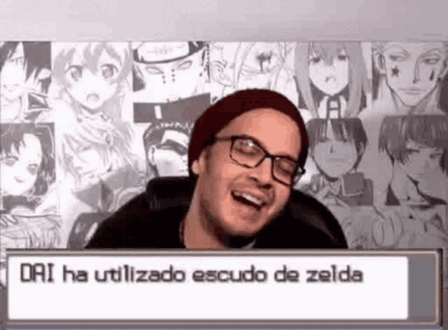 a man wearing glasses and a beanie is laughing in front of a wall with anime characters on it .
