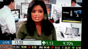 a female news anchor is reporting on a stock market live