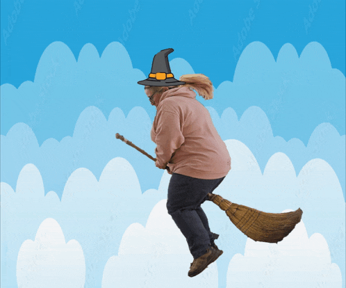 a person in a witch hat is flying on a broom