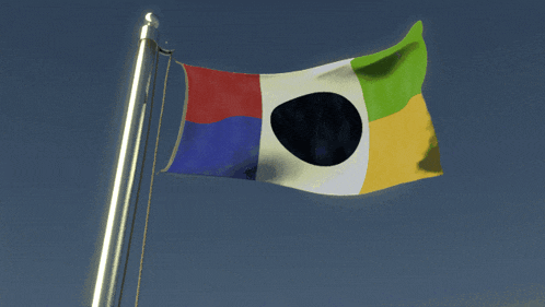 a flag with a black circle in the middle is flying in the wind