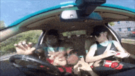 a man and a woman are sitting in a car with a rear view mirror