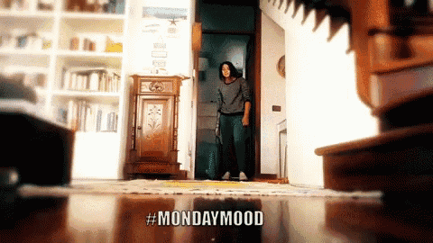 a woman standing in a living room with the words mondaymood written on the floor