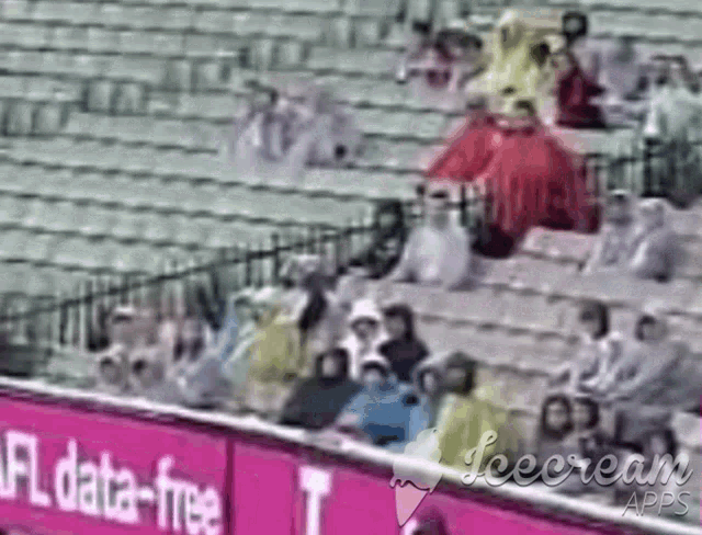 a group of people sitting in a stadium with a sign that says nfl data free
