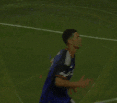 a soccer player wearing a mercy health jersey is running on the field