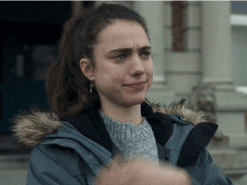 a woman wearing a fur hooded jacket is crying