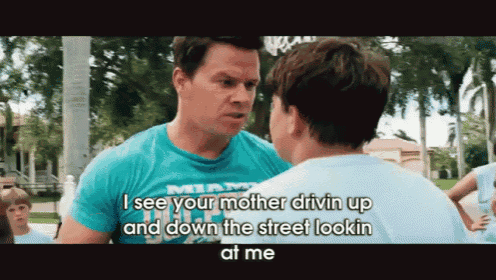 a man in a miami shirt is talking to another man in a white shirt