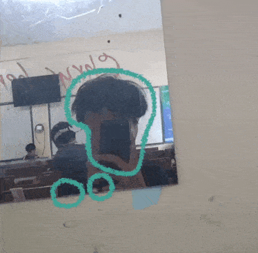 a person is taking a picture of themselves in a mirror with a green circle around their face