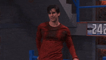 a man standing on a set of stairs with a pepsi can in the background