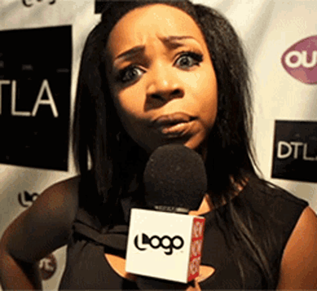a woman is holding a microphone with the logo on it