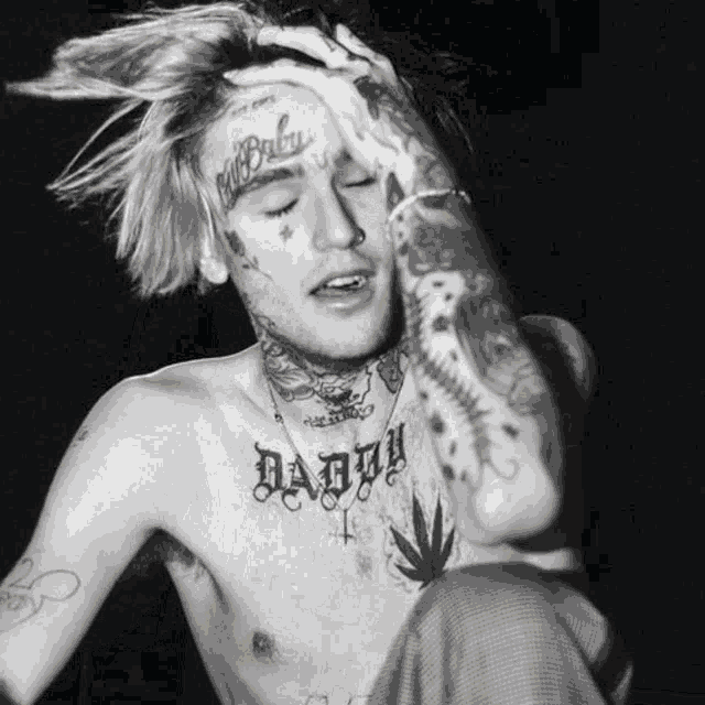 a shirtless man with a tattoo on his chest that says " daddy "