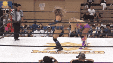 two women are wrestling in a ring with the word masters on the floor