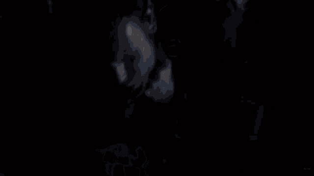 a close up of a person 's arm in the dark