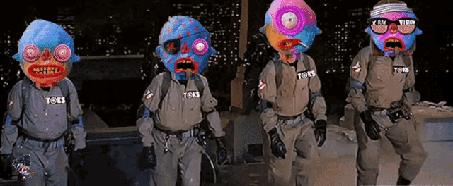 a group of ghostbusters are standing next to each other and their uniforms say toys