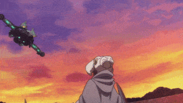 a person looking up at a plane in the sky at sunset