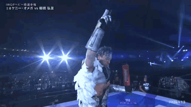 a man in a wrestling ring with the hashtag # njwk13 on the bottom